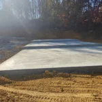 Concrete slab foundation installed for metal building
