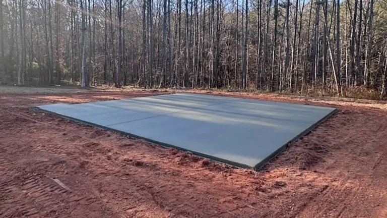 Concrete slab installation for a metal building foundation