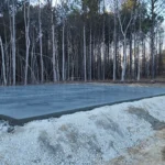 Freshly poured concrete slab drying on construction site